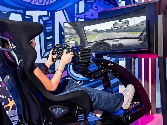 A guest racing on an ImSim simulator inside Venue 56, Kuwait.